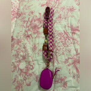 Mini coin holder with shoulder strap.